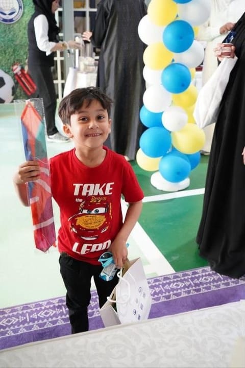 A smiling SIA pupil with his welcome pack